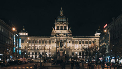 Group of people in illuminated building at night