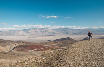 Woman on mountain against sky