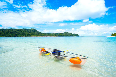 Boat moored in sea against sky