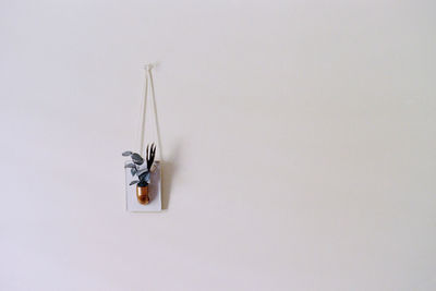 High angle view of metal hanging over white background