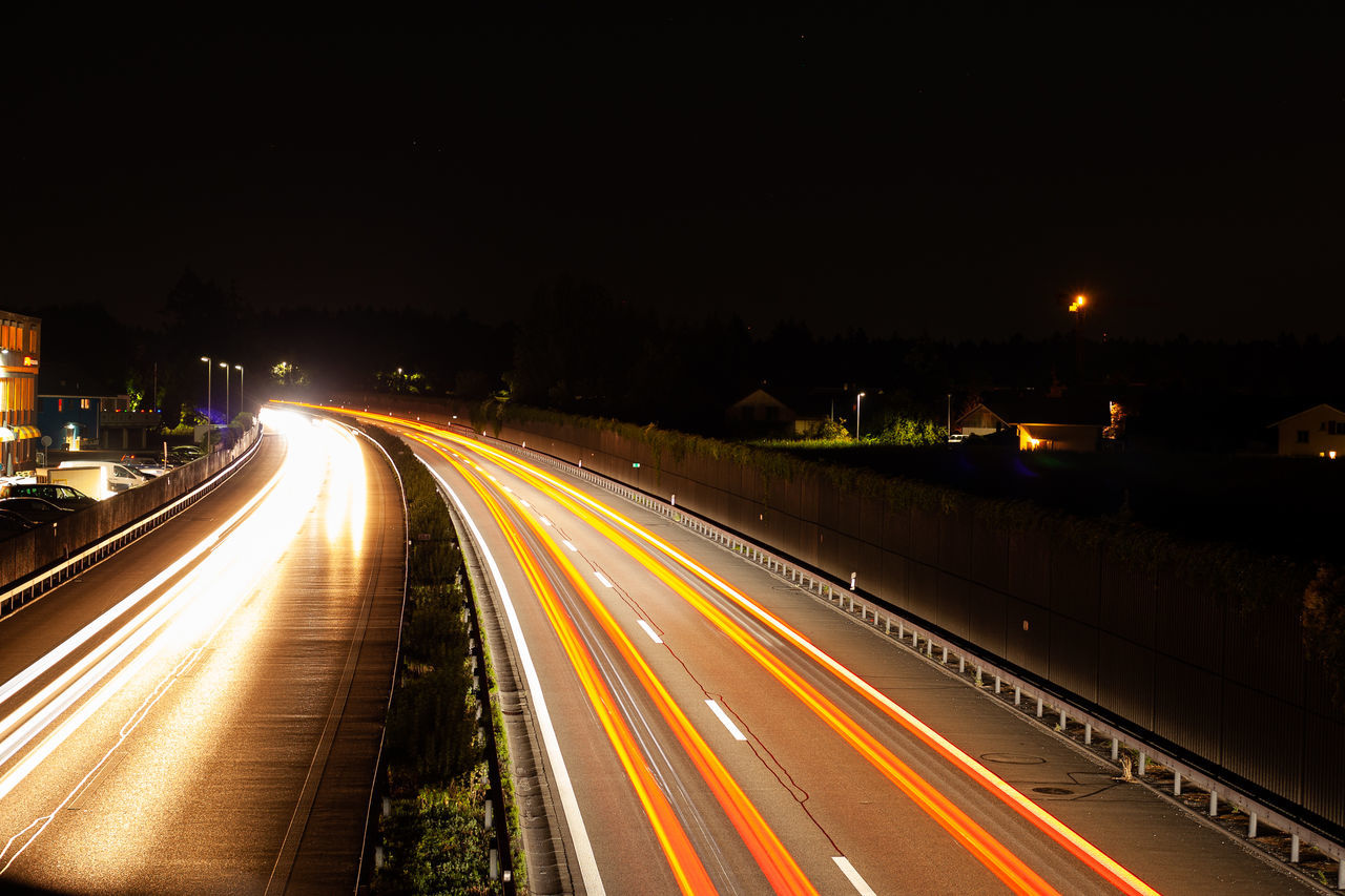 illuminated, long exposure, motion, light trail, night, road, transportation, speed, city, architecture, street, highway, no people, glowing, traffic, blurred motion, city life, street light, the way forward, sky, diminishing perspective, outdoors, multiple lane highway, vehicle light, light