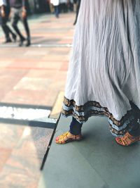 Close-up of woman standing on bench