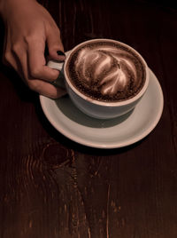Midsection of coffee cup on table