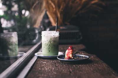 Close-up of milk shake and dessert on table