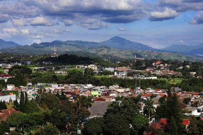 High angle view of townscape and mountains against sky