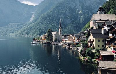 Panoramic view of buildings in town by mountains