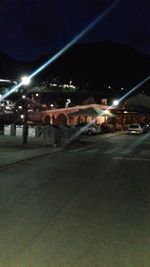 Illuminated city street at night