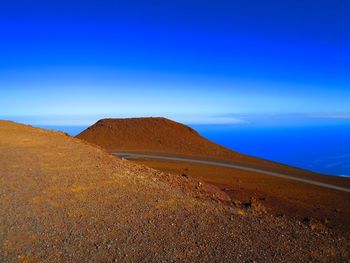 Scenic view of landscape against blue sky