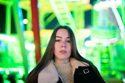 Portrait of beautiful young woman in illuminated dress