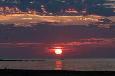 Scenic view of sea against orange sky