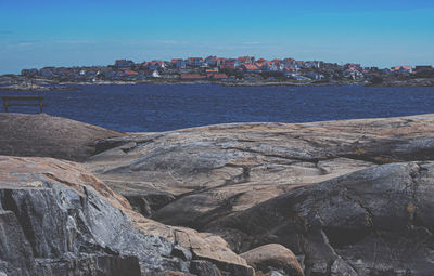 Scenic view of sea by city against sky