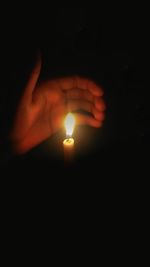 Close-up of human hand against black background