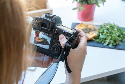 Cropped image of woman photographing