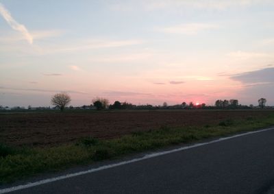 Scenic view of field against sky during sunset