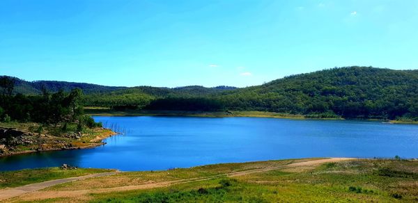 Scenic view of lake against blue sky