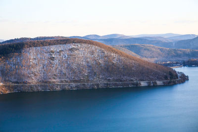 Scenic view of river and mountains against sky