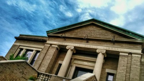 Low angle view of building against cloudy sky