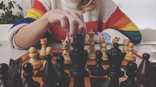 Midsection of woman playing chess