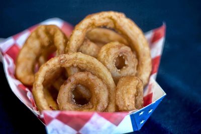 Close-up of onion rings in paper plate on table