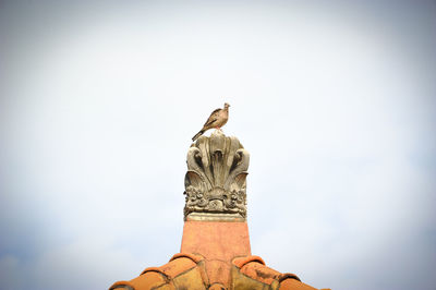 Low angle view of statue against sky