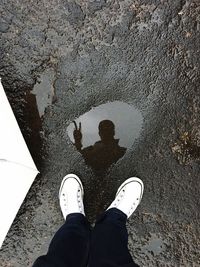 Low section of person standing on street