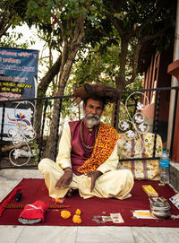 Full length of man sitting on table