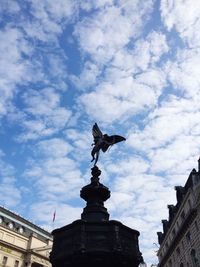 Low angle view of statue against cloudy sky