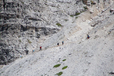 High angle view of people walking on rocks