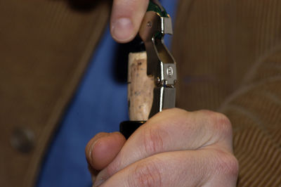 Cropped hand of man repairing machine