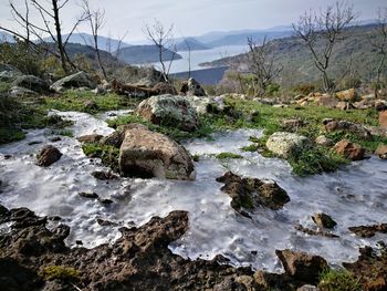 Scenic view of waterfall against sky