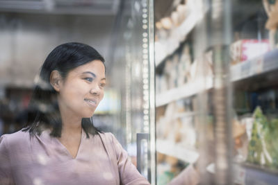 Young woman shopping during inflation in supermarket