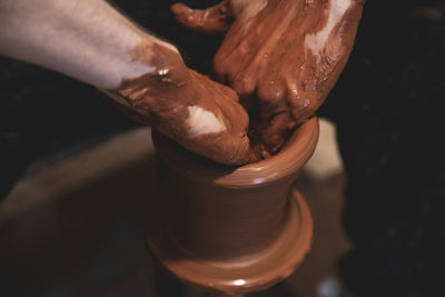 Close-up hands, making pottery