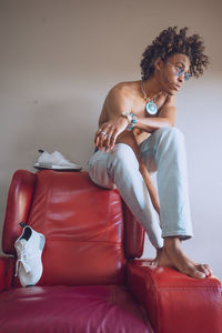 Young man sitting on sofa at home