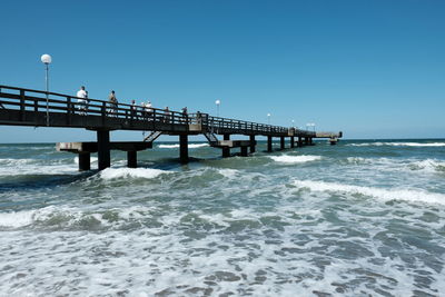 Pier over sea against clear sky