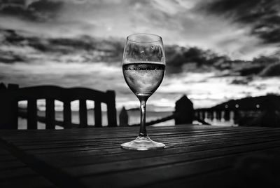 Close-up of beer in glass on table against sky