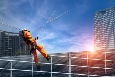 Low angle view of fire escape by building against sky