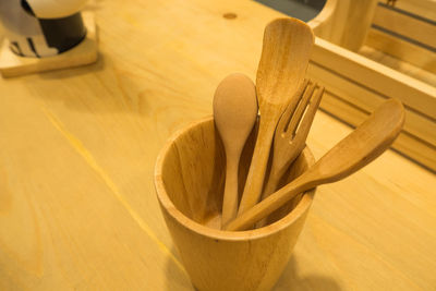 Close-up of wooden eating utensils in desk organizer on table