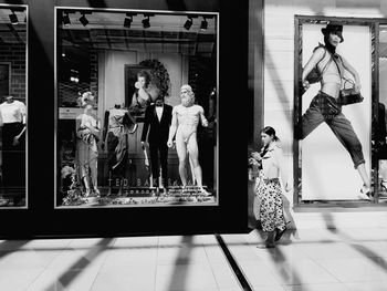 Group of people playing with reflection on tiled floor
