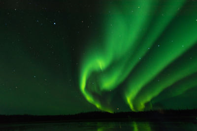 Scenic view of lake against sky at night