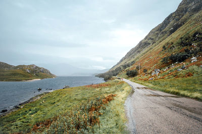 Narrow road along countryside landscape