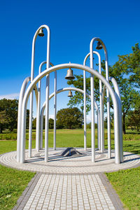 Metallic structure in park against clear blue sky