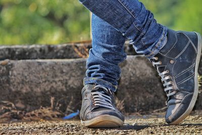 Low section of person wearing shoes standing outdoors