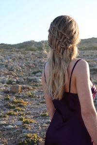 Rear view of woman looking at camera