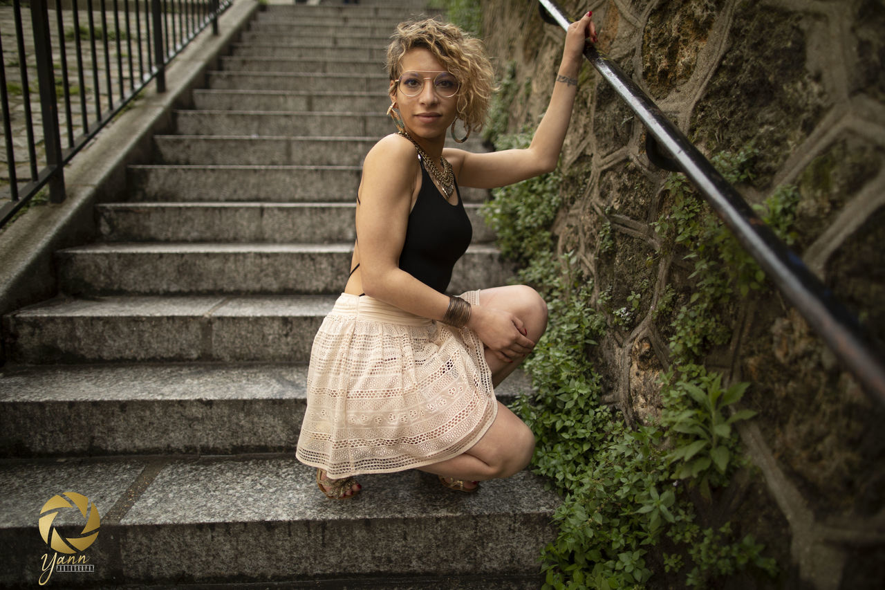 FULL LENGTH PORTRAIT OF WOMAN ON STAIRCASE