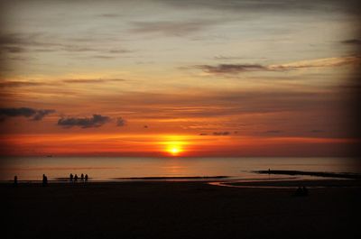 Scenic view of beach against sky during sunset