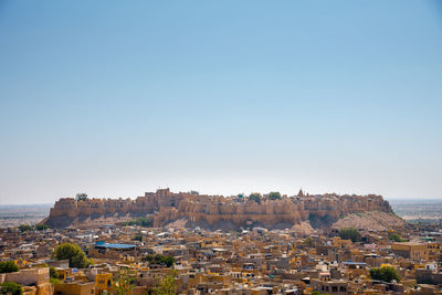 Townscape against clear blue sky