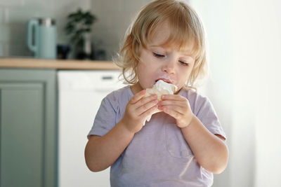 Portrait of cute girl drinking milk at home