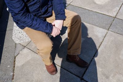 Low section of men standing on street