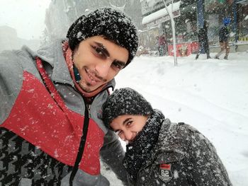 Portrait of a smiling young woman in snow