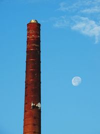 Low angle view of smoke stack against sky